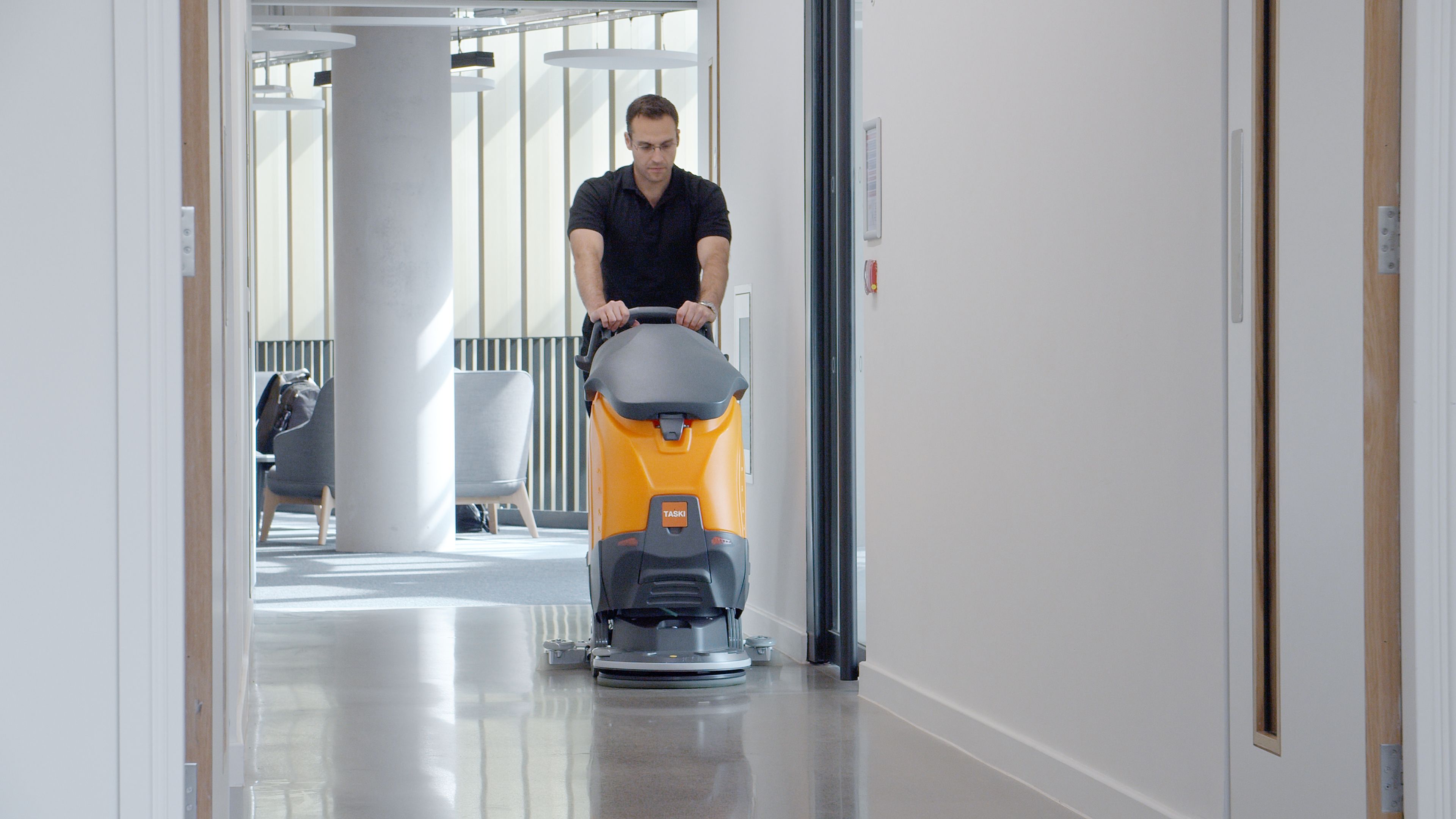 TASKI Ultimaxx floor scrubber — wide production still